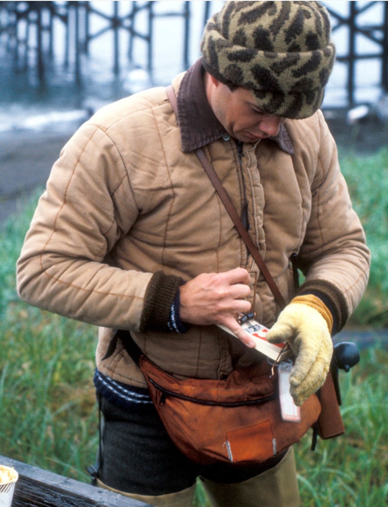 Biologist Jeff Williams from the Alaska Maritime National Wildlife Refuge sets a rodent trap on Kiska Island