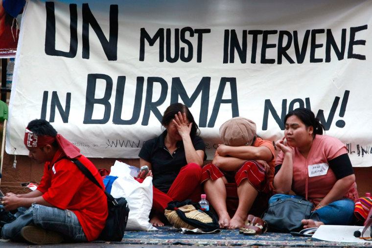 A group of demonstrators sit outside the New South Wales state Parliament House in Sydney