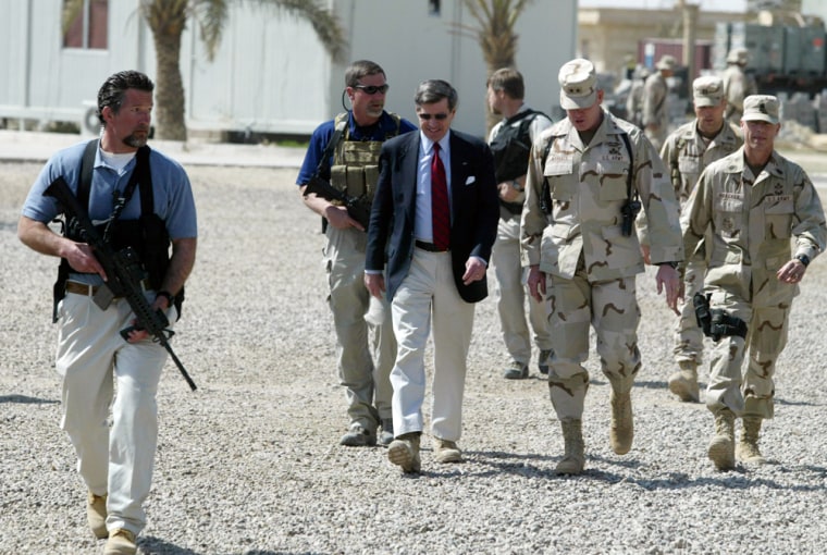 File photo of U.S. civil administrator in Iraq Paul Bremer being escorted by Blackwater personnnel on his arrival at U.S. Army 82nd Airborne Division headquarters in Ramadi