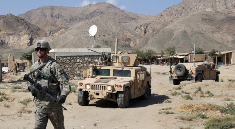 A US soldier walks ahead of a humvee in the Tagab district of Kapisa province, north of Kabul, Afghanistan, in September. The U.S. currently has about 25,000 troops in the country.