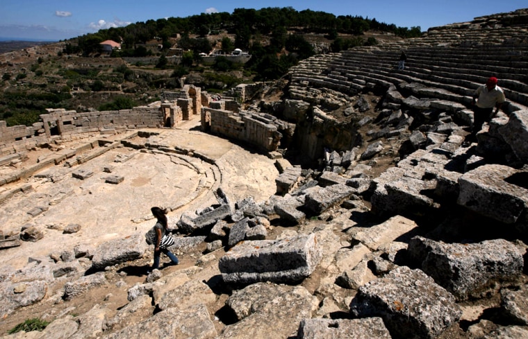 Tourists walk in the 6th century B.C. theater that used to hold 1,000 spectators in the Sanctuary of Apollo at the ancient Greek city of Cyrene, near the city of al-Bayda in northeastern Libya. 