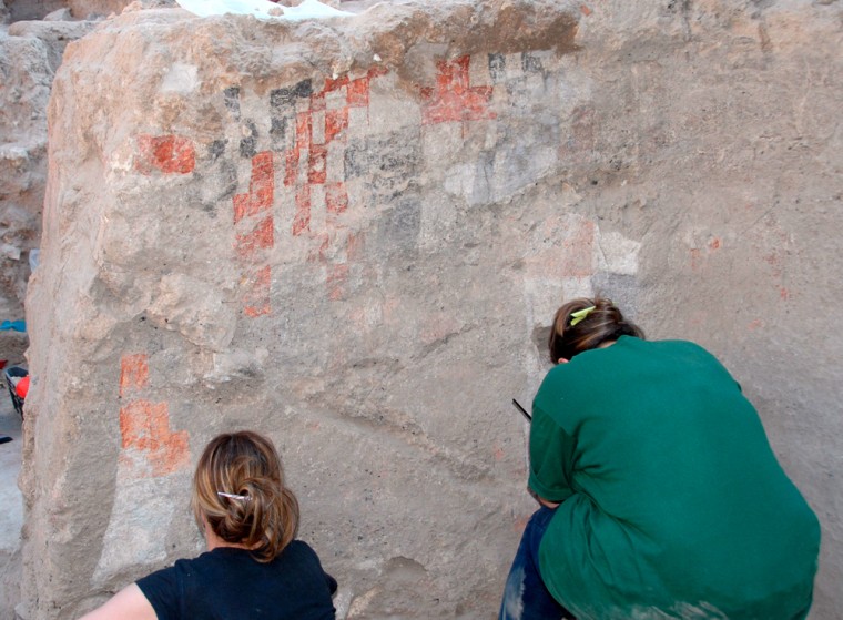 Archaeologists clean a painting believed to date from 11th century BC at Djade al-Mughara Neolihic site in Syria