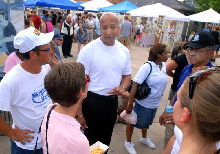 New Orleans Mayor Ray Nagin, center, and Dr. Edward Blakely, right, executive director of recovery management, talk to shoppers at the Freret Market, the second target recovery project to be announced, in New Orleans, Sept. 8.