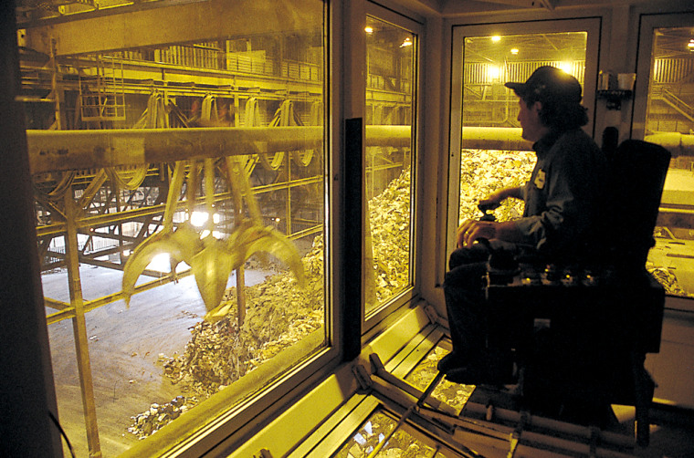 A crane operator sorts garbage at a Waste Management plant in Florida that produces electricity from methane gases.