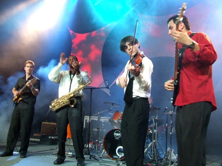 The OneUps, a video-game cover band from Fayetteville, Ark., play at the Penny Arcade Expo in Seattle. From left: Guitarist William Reyes, saxophonist Anthony Lofton, violinist Greg Kennedy and bassist Mustin. 