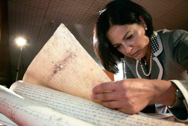 Publicist Rosy Fontana reads a replica document in which Pope Clement V absolved the Knights Templar of charges of heresy, in Rome