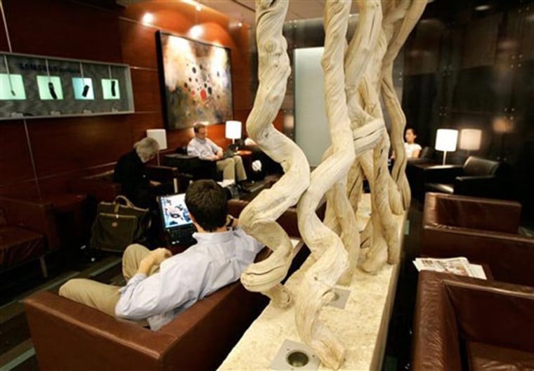 Air travelers relax in a cozy lounge at the Dallas-Fort Worth International Airport in Texas. The lounge features internet access, leather chairs, flat-panel TVs and dozens of all-important power outlets, all of it free. Travelers at other airports aren't always so fortunate, and membership of an airline club or a credit card's lounge-pass program can make good sense for frequent travelers.