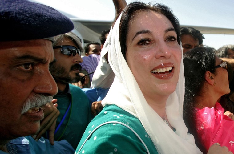 Former Pakistani Prime Minister Benazir Bhutto smiles as she lands at Karachi international airport after leaving Dubai, 18 October 2007. Bhutto is returning to the country after eight years of self imposed exile when she faced charges of corruption. U.S officials have backed a possible power-sharing deal between Bhutto and currrent Pakistani President, General Pervez Musharraf. Almost 20,000 troops and police have been deployed in Karachi amid threats by Islamist militants to assassinate both Musharraf and Bhutto on her return. AFP PHOTO/CARL DE SOUZA (Photo credit should read CARL DE SOUZA/AFP/Getty Images)