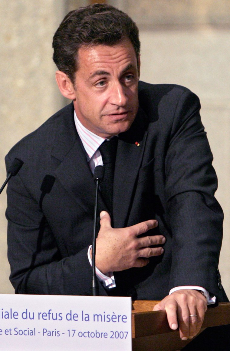 France's President Sarkozy gestures as he delivers a speech before the French Economic and Social Council, marking World Poverty Day in Paris