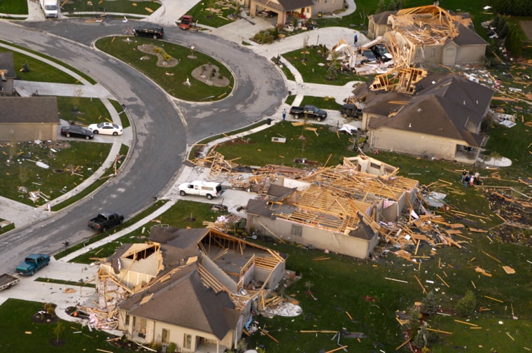 Debris surrounds homes in Nappanee, Ind., Friday after an apparent tornado hit the town about 20 miles southeast of South Bend Thursday. Police said several people were taken to hospitals with minor injuries.