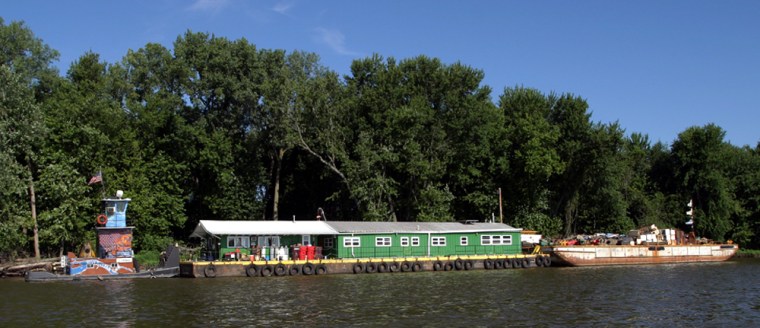 Pregracke's group uses a multicolored towboat and four barges – three laden with piles of garbage reclaimed from the river and the fourth floating the living quarters for Pregracke and his crew – to steam back and forth between St. Louis and the upper Mississippi to conduct cleanups, support shoreline tree-planting outings or host educational workshops.