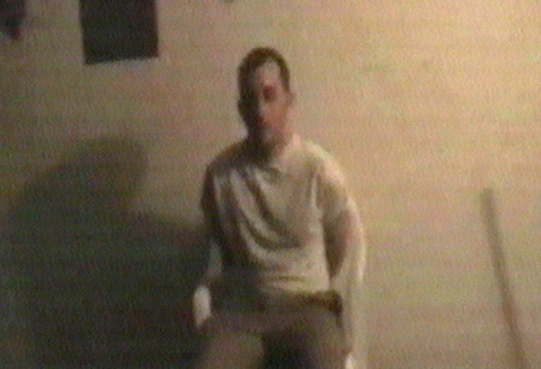 This is a image from a video aired Saturday, Aug. 7, 2004 taken from a Website which purportedly shows a man who identifed himself as Benjamin Vanderford from San Francison sat on a chair in a dark room, his hands behind his back, trembling and rocking back and forth. In the tape he urges the United States to end its occupation of Iraq.  The video then showed him beheaded with a large knife. Unlike in previous videos of hostage killings, no militants were seen on the footage. He was clad in a t-shirt, not the orange jumpsuit that other hostages have been dressed in. EDS NOTE AP ARE UNABLE TO VERIFY THE AUTHENTICITY OF THIS IS IMAGE  (AP Photo/APTN)
