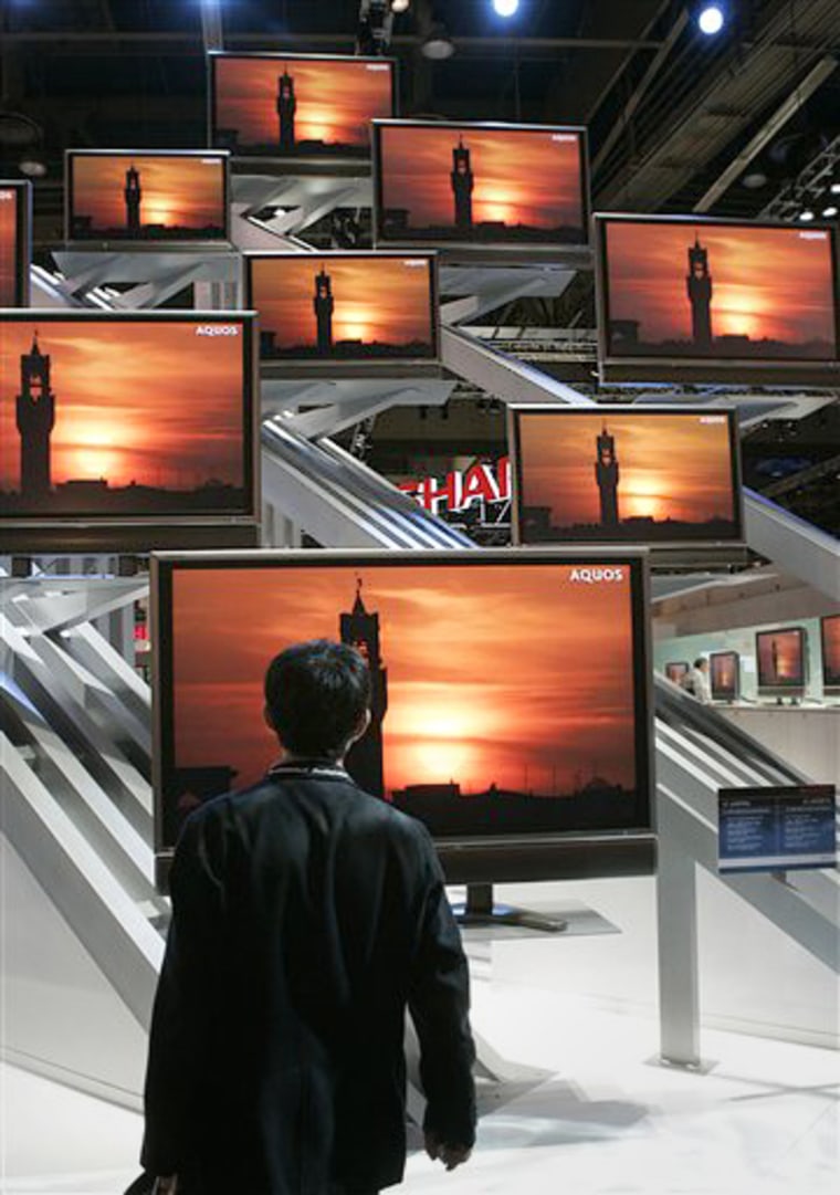 A man gazes at Sharp's flat-panel television display at the Consumer Electronic Show on Jan. 8. While most retail sectors fall off after Christmas, TV sales get continued life thanks to the Super Bowl and other popular sporting events.