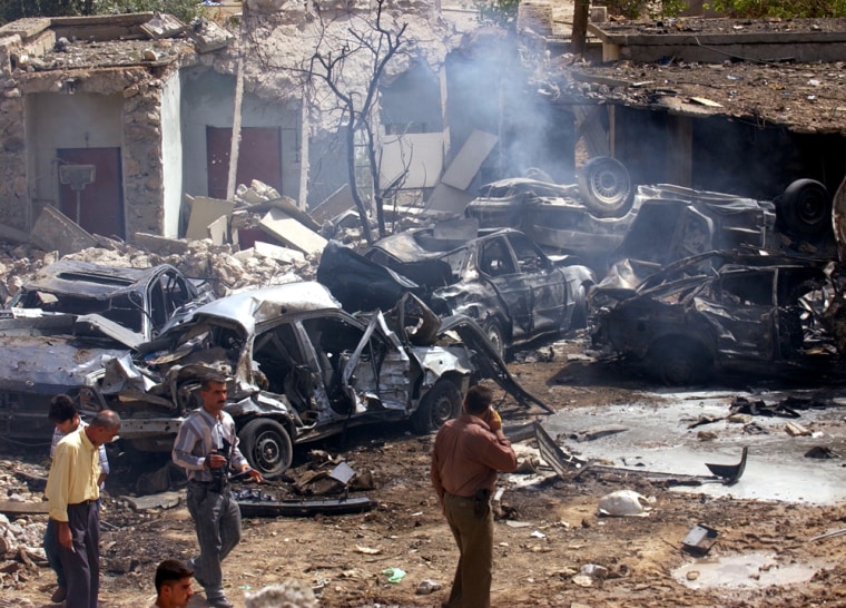 Iraqis view damaged vehicles after a suicide car bomb attack in Kirkuk, 180 miles north of Baghdad, Iraq, on Sunday.