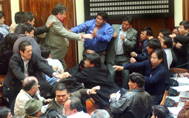 Bolivian opposition lawmakers, left, clash with governmental counterparts during a session at the National Congress on Wednesday.