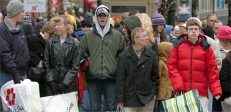 Holiday shoppers wait to cross the street, Friday, November 28, 2003 in Chicago. The streets of Chicago were crowded with shoppers on the day after Thanksgiving, the traditional start of the holiday shopping season. (AP Photo/Jeff Roberson)