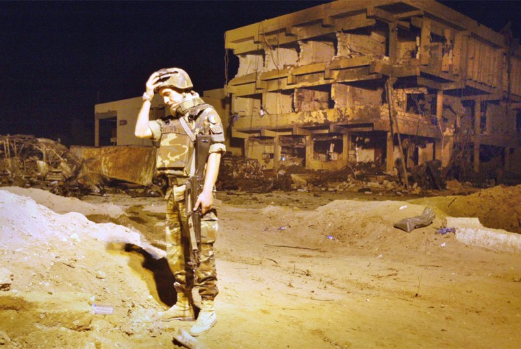 An Italian soldier grieves for slain colleagues beside the barracks in Nasiriyah, Iraq, destroyed by a bombing Nov. 12.