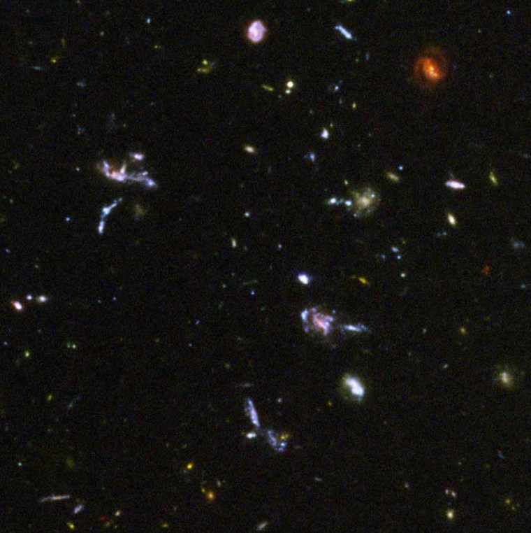 The area in this image is littered with encounters between galaxies that have been shredded by the interactions.