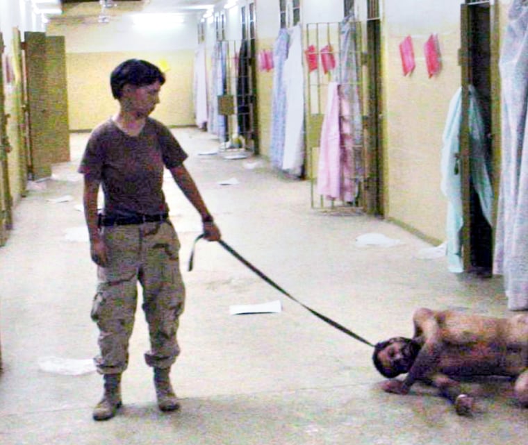 SOLDIER HOLDS A LEASH OF AN IRAQI PRISONER IN IMAGES RELEASED BY THE WASHINGTON POST