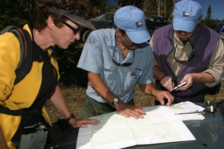 Local rancher Peggy Dulaney, PV, and Richard pour over the USGS maps of the west side of the Mt. Sawtell planning the hike to the source of the Missouri.