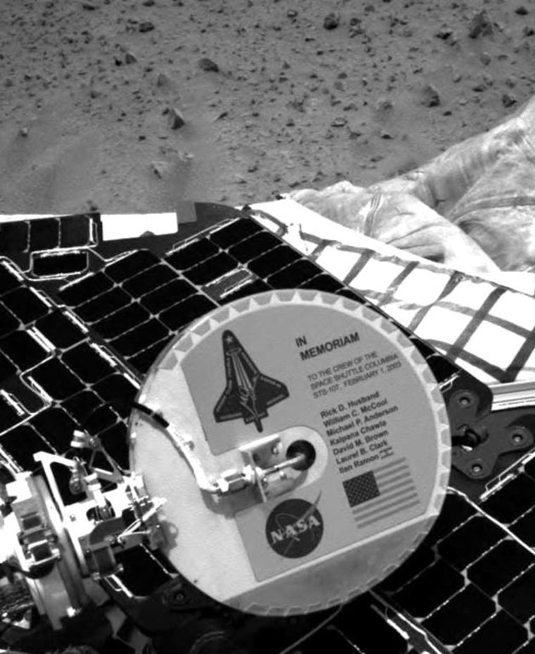 Since its historic landing, Spirit has been sending extraordinary images of its new surroundings on the red planet over the past few days. Among them, an image of a memorial plaque placed on the spacecraft to Columbia's astronauts and the STS-107 mission. 

The plaque is mounted on the back of Spirit's high-gain antenna, a disc-shaped tool used for communicating directly with Earth. The plaque is aluminum and approximately six inches in diameter. The memorial plaque was attached March 28, 2003, at the Payload Hazardous Servicing Facility at NASA's Kennedy Space Center, Fla. Chris Voorhees and Peter Illsley, Mars Exploration Rover engineers at NASA's Jet Propulsion Laboratory, Pasadena, Calif., designed the plaque. 

\"During this time of great joy for NASA, the Mars Exploration Rover team and the entire NASA family paused to remember our lost colleagues from the Columbia mission. To venture into space, into the unknown, is a calling heard by the bravest, most dedicated individuals,\" said NASA