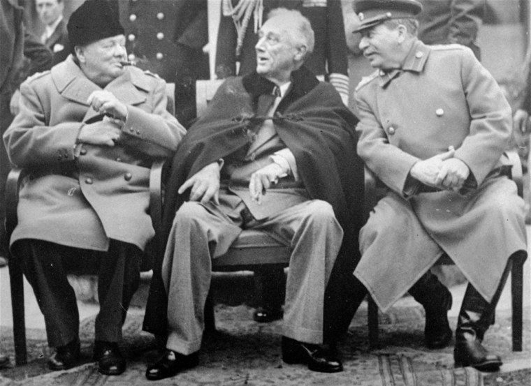 Prime Minister Winston Churchill, left, smokes a cigar with President Franklin D. Roosevelt, center, and Russian Marshal Josef Stalin, while conferring in the Livadia Palace gardens, in Yalta, February 12, 1945.  (AP Photo)
