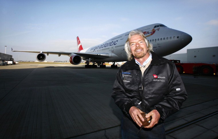 Richard Branson poses in front of a Virg