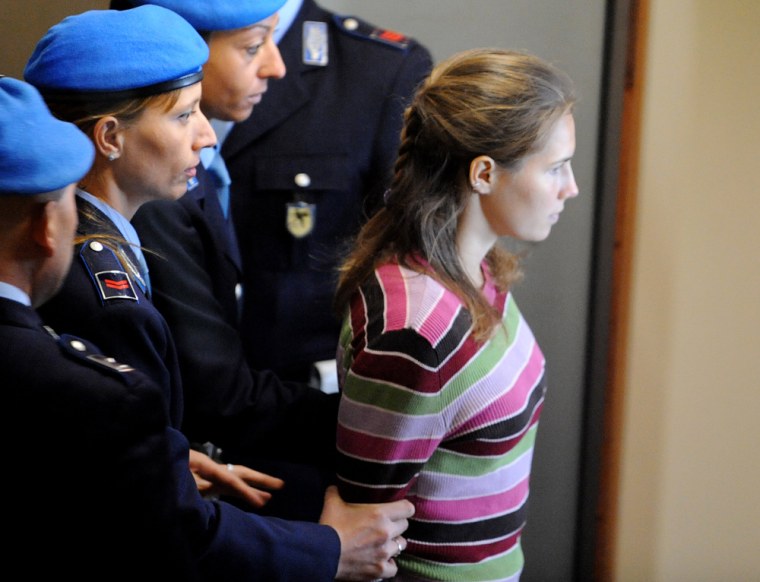One of the three suspects in the murder of British student Meredith Kercher, Amanda Knox from the US, arrives at a court hearing in Perugia on September 27, 2008. Kercher, 22, a student from Leeds University studying in Perugia as part of the Erasmus exchange programme, was found dead in her Perugia flat on November 1, 2007 with her throat cut. AFP PHOTO/Tiziana Fabi (Photo credit should read TIZIANA FABI/AFP/Getty Images)