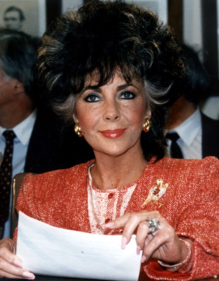 Movie star Elizabeth Taylor smiles as she appears