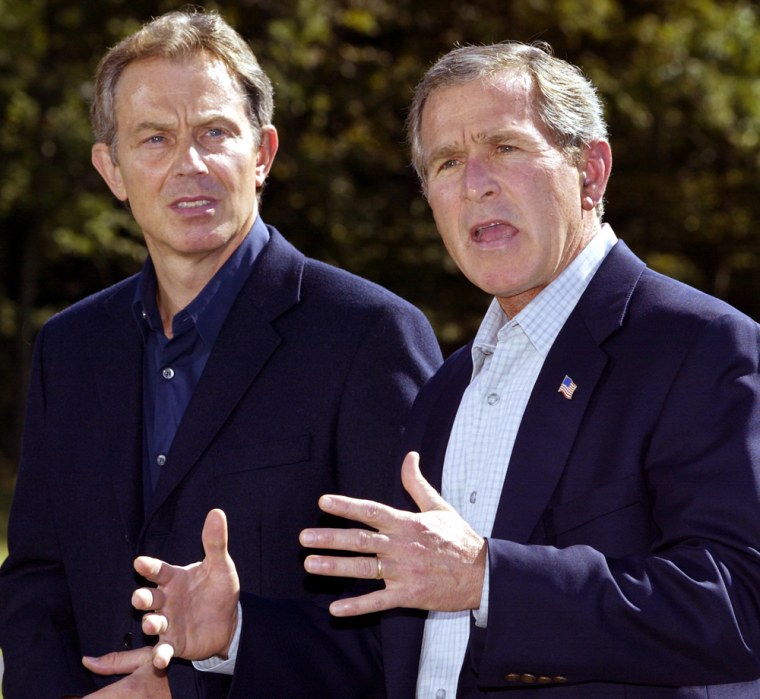 US President George W. Bush (R) and British Prime Minister Tony Blair (L) deliver statements to the media after Blair's arrival, 07 September 2002, at the US presidential retreat, Camp David, Maryland. Blair is meeting privately with the US President to discuss possible military intervention in Iraq.      AFP PHOTO/PAUL J. RICHARDS