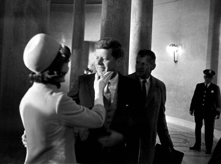Mrs. John F. Kennedy had a chuck under the chin for her husband moments after he became President, January 20, 1961.  This exclusive picture by AP photographer Henry Burroughs, was taken in the rotunda of the capitol just after President Kennedy left the inaugural stand.  (AP Photo/Henry Burroughs)
