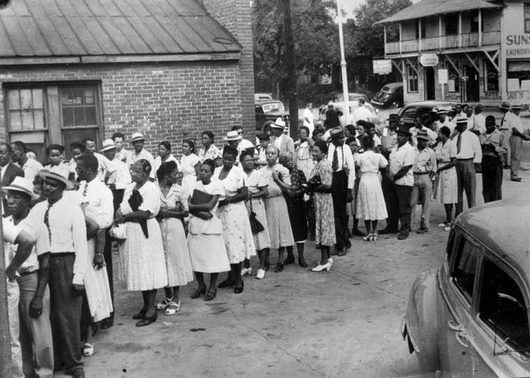 Black Americans line up to receive ballots at Columbia, S.C., as members of the black community vote in a South Carolina Democratic primary for the first time since 1876 on Aug. 10, 1948.  In 1944, the U.S. Supreme Court ruled that blacks cannot be denied the right to vote in primary elections.  (AP Photo)