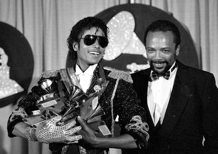 Michael Jackson holds six of his eight awards we won back stage at the 26th Annual Grammy Awards in Los Angeles Tuesday, Feb., 28, 1984. (AP Photo)