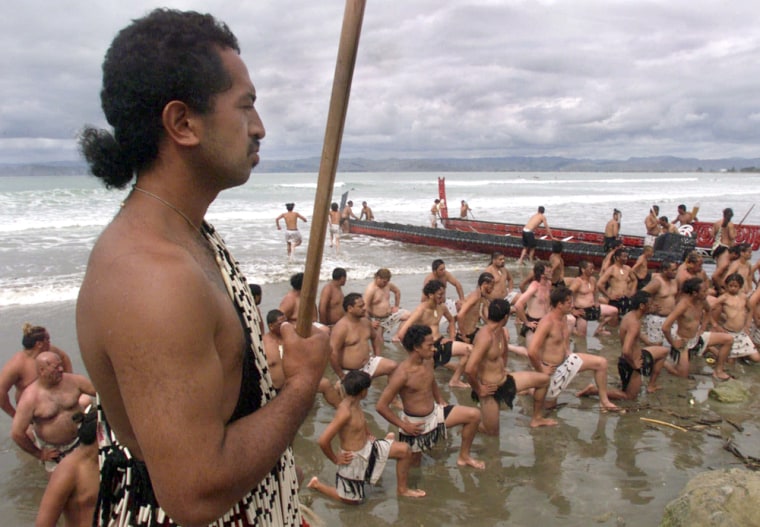 Ethnic Maori men from Gisborne, New Zealand take positions on the beach after the arrival by boat of elders from Cook Island  Wednesday Dec.  29, 1999 to join in Gisborne's millennium celebrations. History has been harsh to the indigenous Maori and Moriori of New Zealand, but their resurgent cultures will be center stage when the country becomes the first major nation to enter the new millennium. (AP Photo/David Guttenfelder)