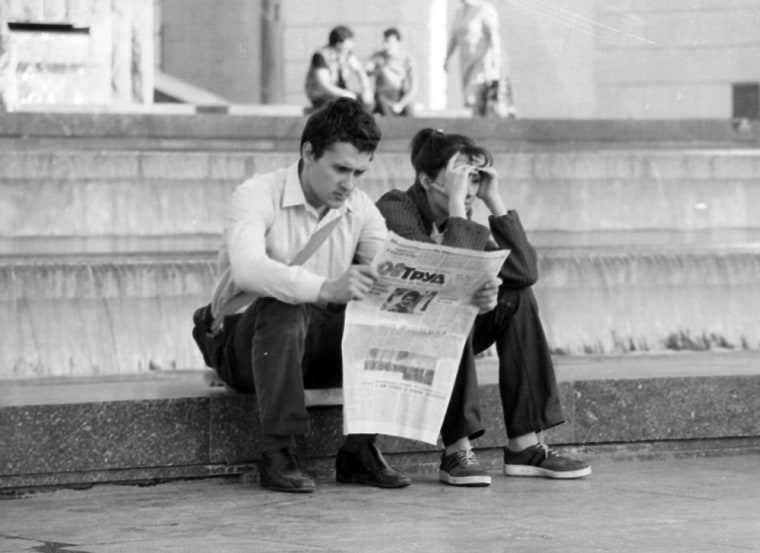 A young Kiev resident reads about the Chernobyl nuclear accident in the Prud newspaper, April 1986.  (AP Photo/Boris Yurchenko)