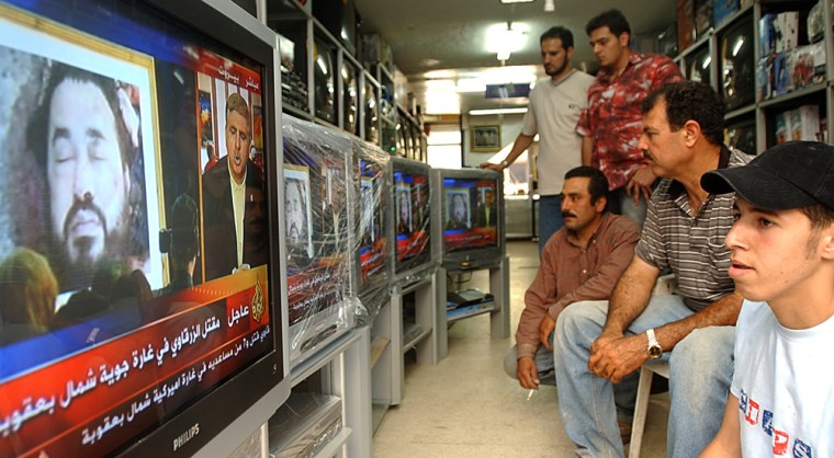 Lebanese citizens in an electronics shop watch on TV the latest image purporting to show the body of Abu Musab al-Zarqawi, the al-Qaida-linked militant who led a bloody campaign of suicide bombings, kidnappings and hostage beheadings in Iraq, who was killed Wednesday in a U.S. airstrike in Iraq, at the southern port city of Sidon, Lebanon, Thursday June 8, 2006. Red banners with urgent tags appeared on many Arab TV stations Thursday, as the region's major stations broke into regular programming to announce some of the biggest news in months, the death of terrorist Abu Musab al-Zarqawi. (AP Photo/Mohammed Zaatari)