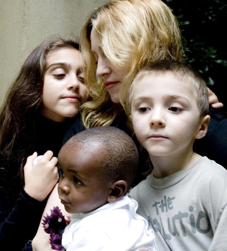 U.S. singer Madonna poses with daughter Lourdes, son Rocco and Malawian boy Banda in central London