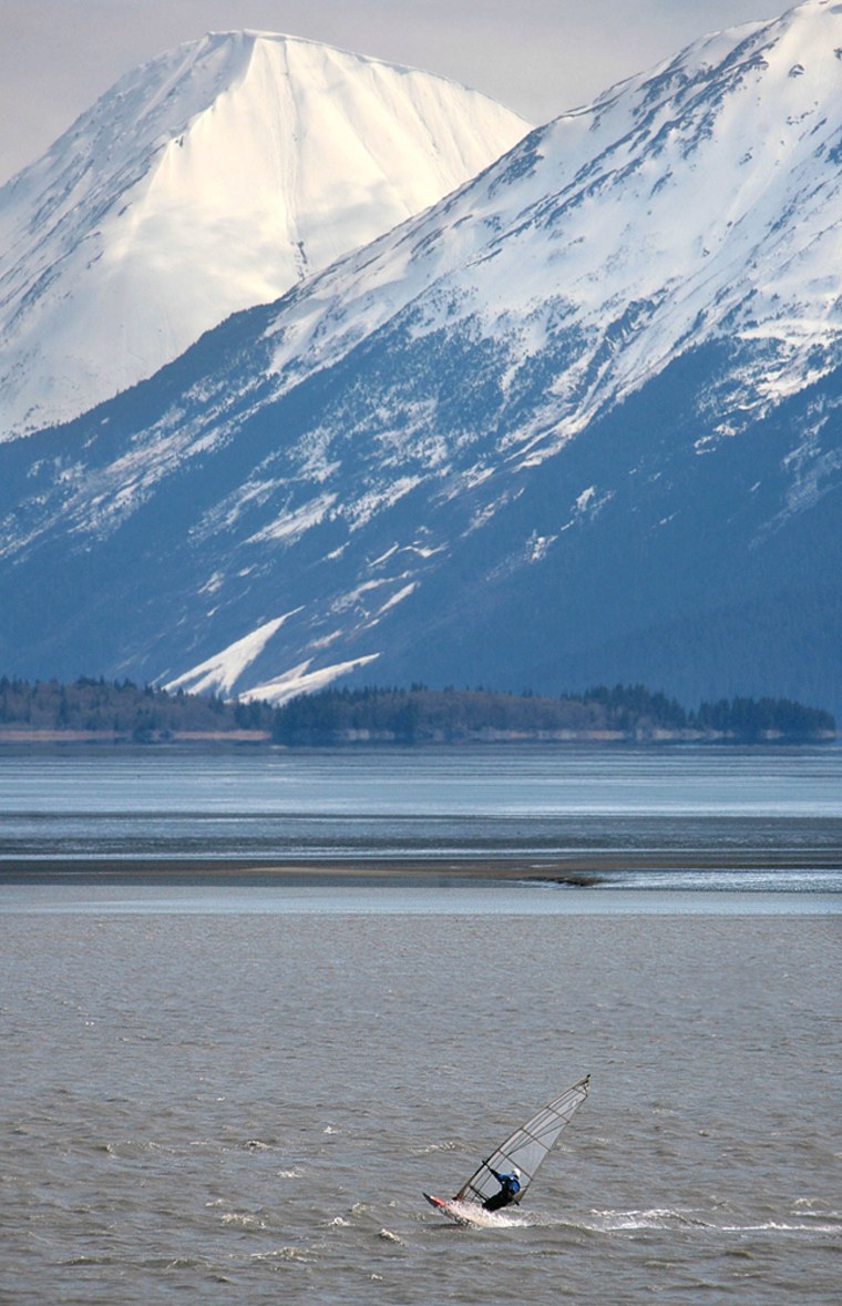 A windsurfer rides the wind as he jumps across waves in the Turnagain Arm south of Anchorage, Alaska, Thursday, May 18, 2006.  (AP Photo/Al Grillo)