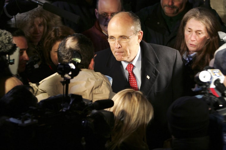 Former New York City mayor Giuliani listens to a question from the media in Floral Park