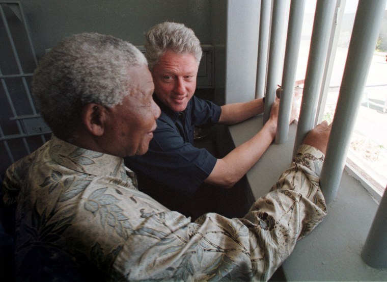 CLINTON LOOKS TOWARD MANDELA INSIDE MANDELA'S PRISON CELL