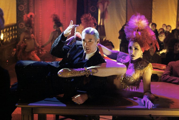 Gere showed he could sing and dance in Bill Condon's Academy Award-winning film \"Chicago\" (2002). He plays attorney Billy Flynn, who tries to save Roxie Hart (Renee Zellweger, not pictured) from a murder rap.