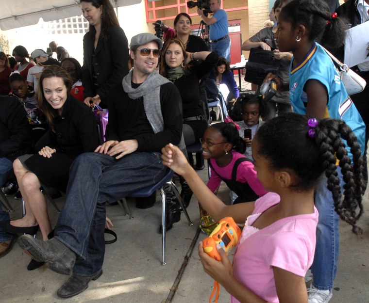 Angelina Jolie and Brad Pitt talk and pose for children affected by Hurricane Katrina who were photographing them New Orleans, Saturday, Dec. 22, 2007.Jolie joined with The Children's Health Fund to find ways to help the reportedly thousands of displaced children who are showing mental and physical problems likely due to hurricanes Katrina and Rita. (AP Photo/Cheryl Gerber)