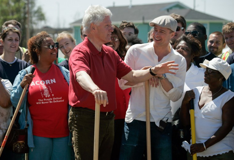 Former U.S. President Clinton speaks with Brad Pitt and community members in New Orleans
