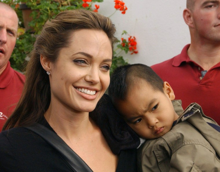 Movie star Angelina Jolie with her son Maddox at the Live 8 Africa Calling concert, held at the Eden Project in Cornwall, England, Saturday, July 2, 2005. From Johannesburg to Philadelphia, from Berlin to Barrie, Ontario, musicians and fans were gathering for a global music marathon to raise awareness of African poverty and pressure the world's most powerful leaders to do something about it at the Group of Eight summit in Scotland next week.  (AP Photo/Ian West/PA)  **  UNITED KINGDOM OUT NO SALES  **