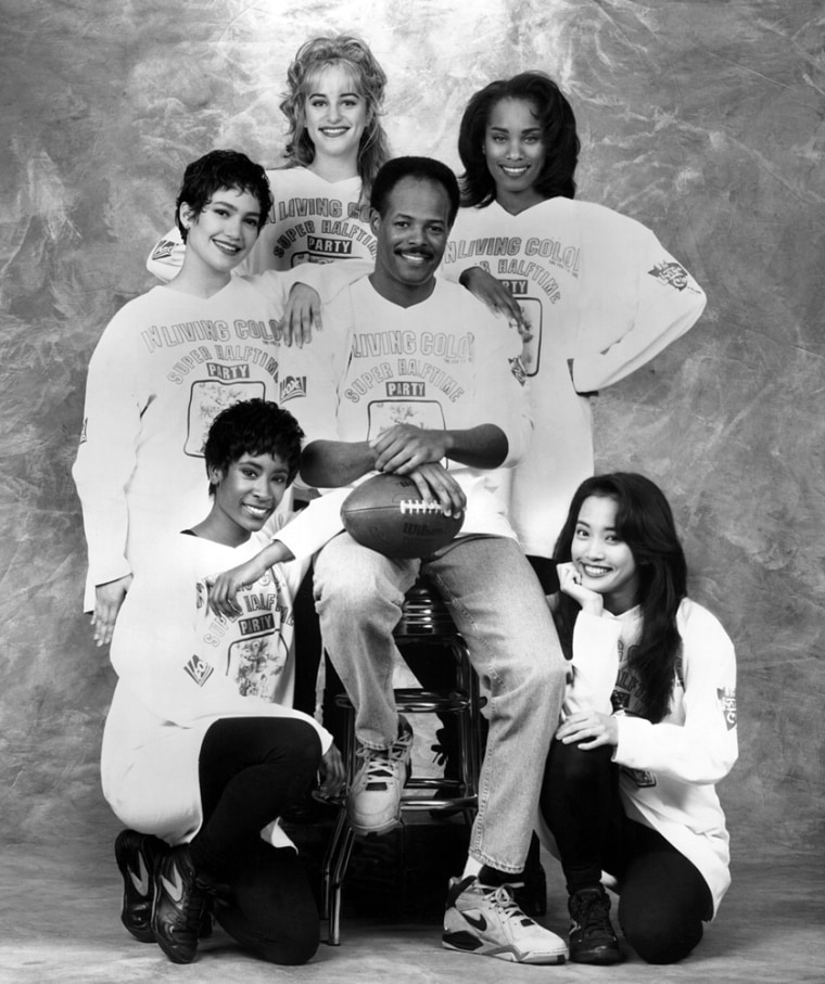 Jennifer Lopez with hand on Keenen Ivory Wayans' shoulder in promo shot for IN LIVING COLOR SUPER HALFTIME PARTY, 1992 Lopez gained her first regular high-profile job as a \"Fly Girl\" dancer on the television comedy program In Living Color in 1991.