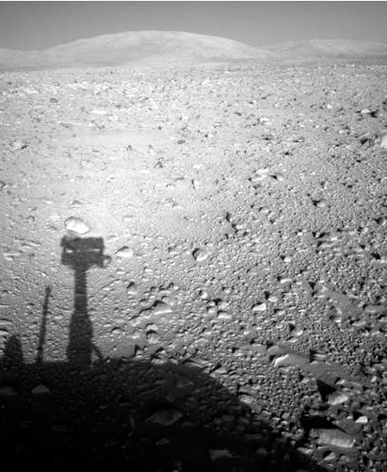 NASA's Spirit rover takes a picture of its own shadow with the Columbia Hills in the distance. The rover experienced a computer glitch a day after it took this snapshot.