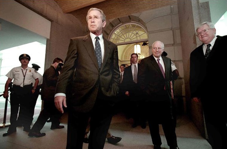 President Bush answers press questions before his meeting with the Republican Joint House and Senate closed caucus in the Capitol in February 2001. In the background are House Speaker Dennis Hastert, right, and Vice President Dick Cheney, center.