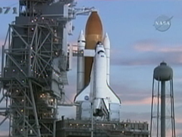 The shuttle Atlantis sits on its launch pad at NASA's Kennedy Space Center in the wake of Sunday's launch postponement.