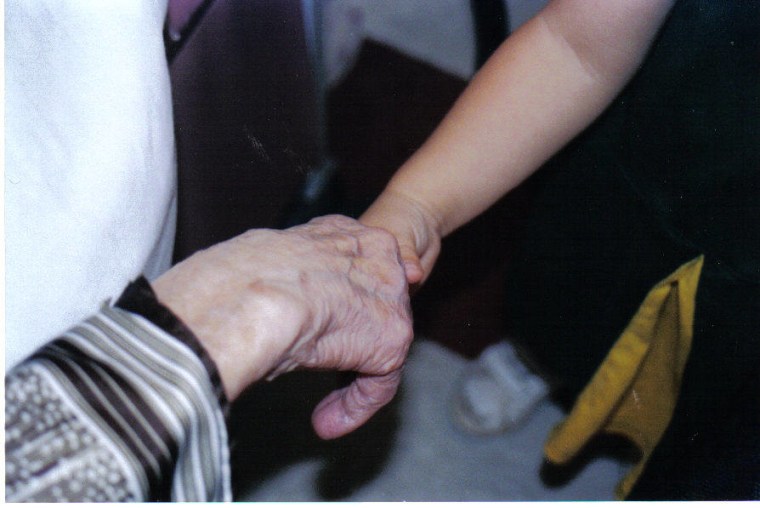 Grandma sharing a handshake with her 3 year old granddaughter. She was always ready to give a hand to help all of us!
