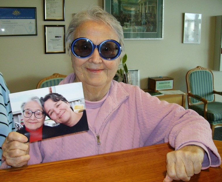 My mother, showing off a picture of the two of us at her Australian facility's reception. (they email me with pictures of her!)